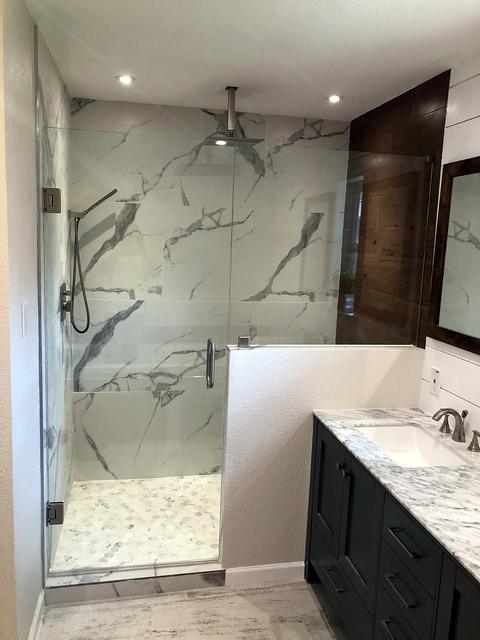 Marble-look walk-in shower with frameless glass